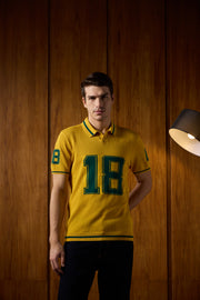 THE VARSITY MESH POLO IN ATHLETIC GOLD